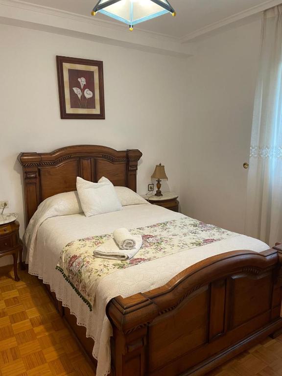 a bedroom with a bed with a phone on it at Casa Diego in Muñón Fondero