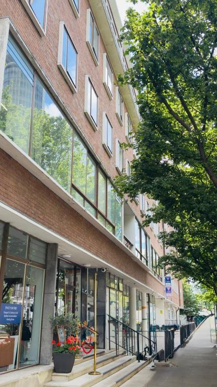 a large brick building with windows on a street at YMCA Hotel in London