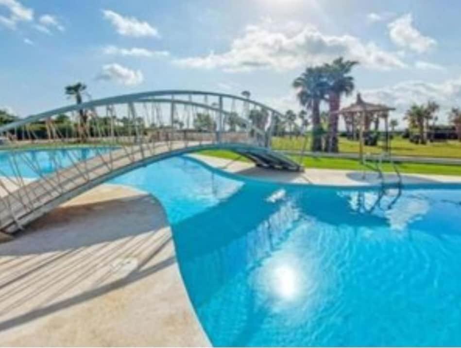 a bridge over a swimming pool in a park at Luc61 - Vistas al mar in La Estación