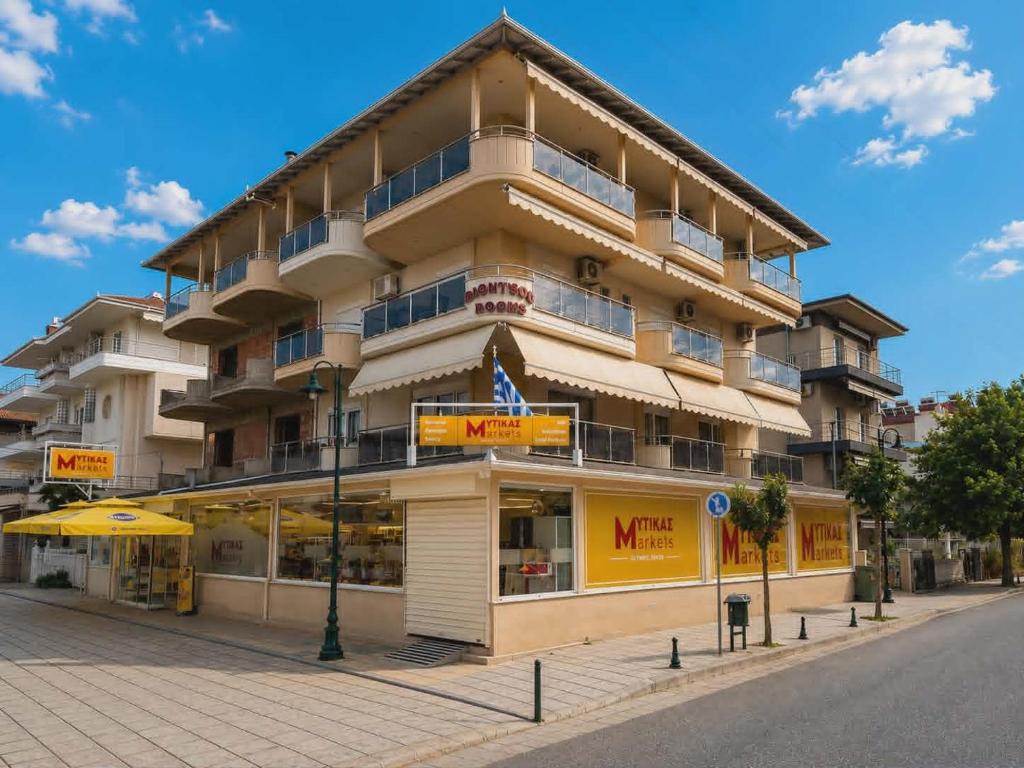 a large building on the side of a street at Dionysos Rooms in Olympic Beach