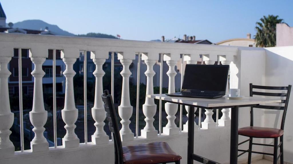 a laptop computer sitting on a table on a balcony at Atlantis Apart Hotel in Marmaris