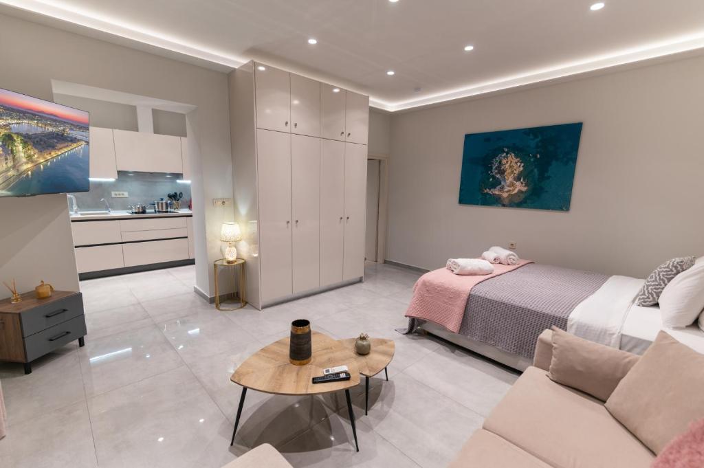 a bedroom with a bed and a couch and a table at Unique Kos Apartment in Ampavris