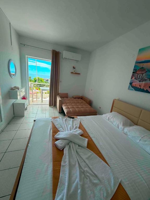 a bedroom with two beds and a view of the ocean at Panagiota Lounge Sea View in Kanali