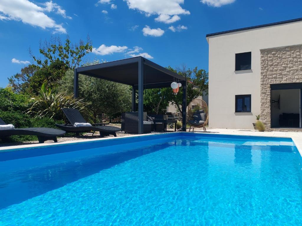 a swimming pool in front of a house at Lazy 8 Villa in Garica