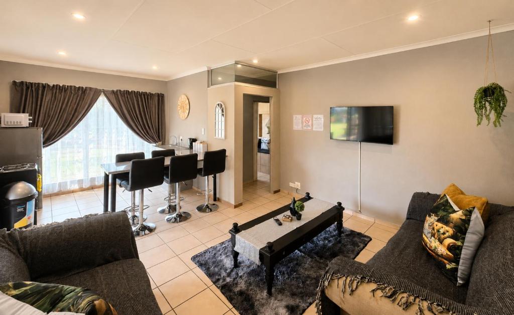 a living room with a couch and a table at Zhantique Guest House 2- Unit 6 in Boksburg