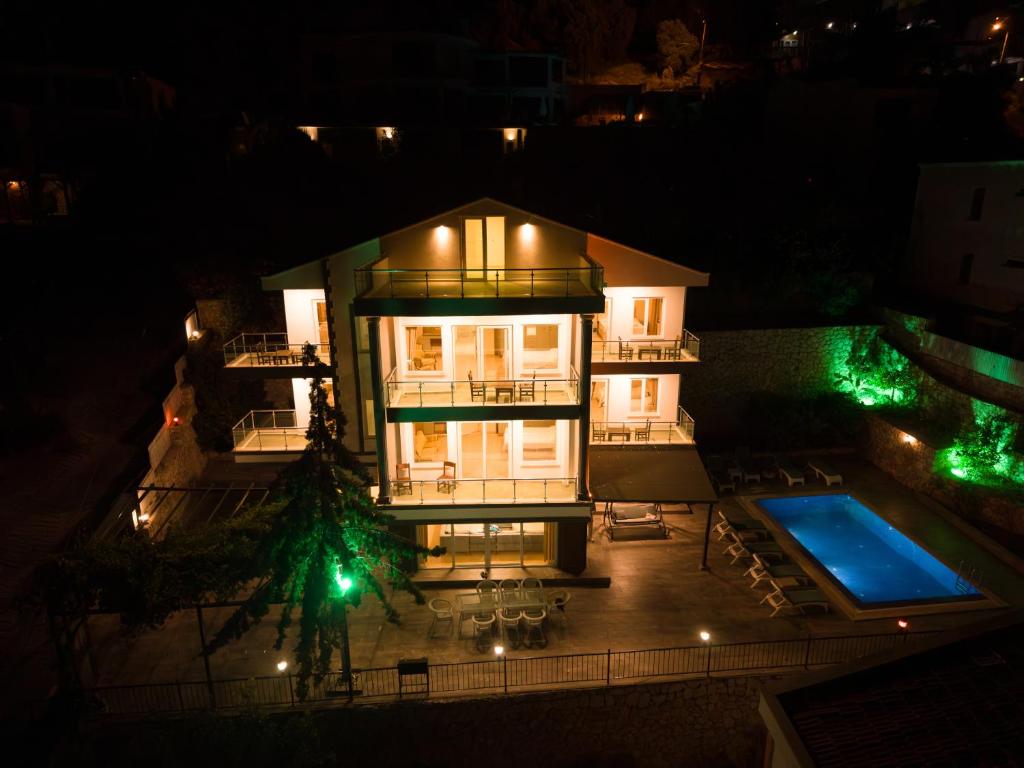 an aerial view of a house at night with a swimming pool at Villa Mevsim in Kaş