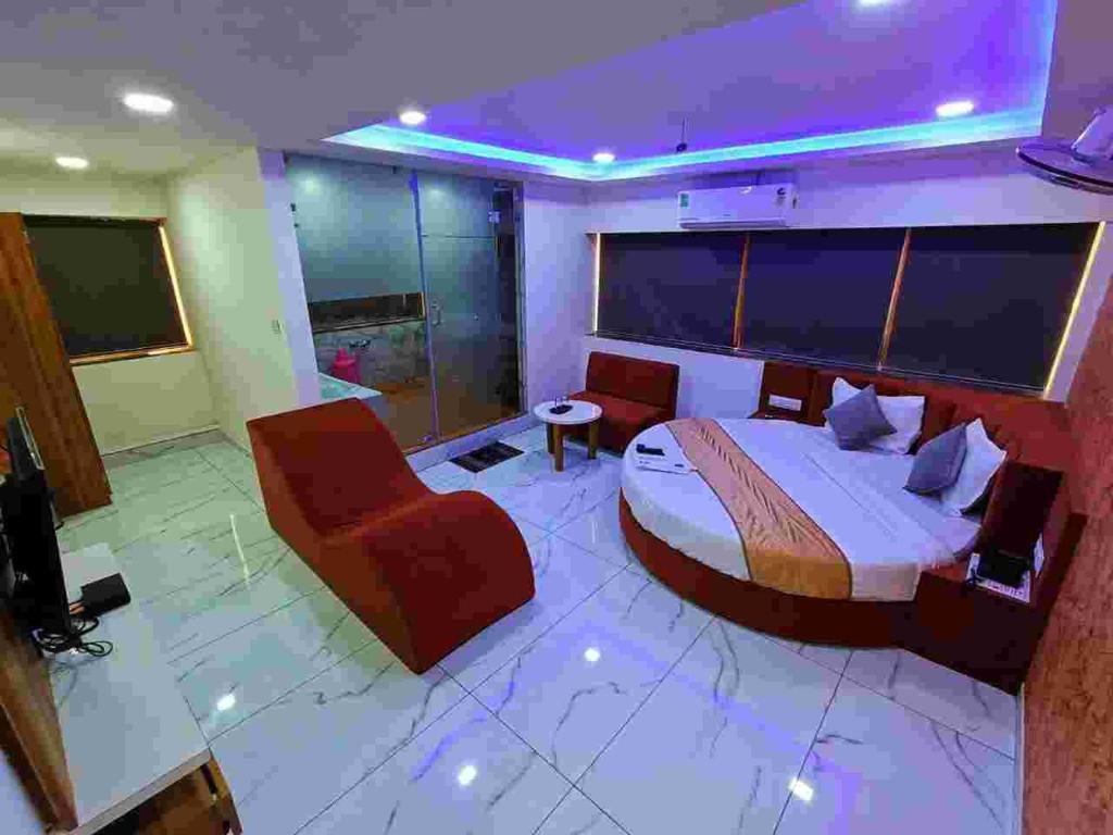 a hotel room with a bed and a tv at HOTEL ROCK In in Anand