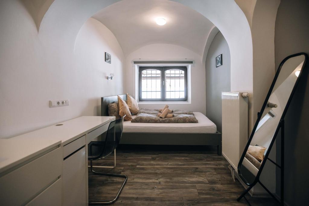 a bedroom with a bed in a room with a window at 4 Rooms in Maribor