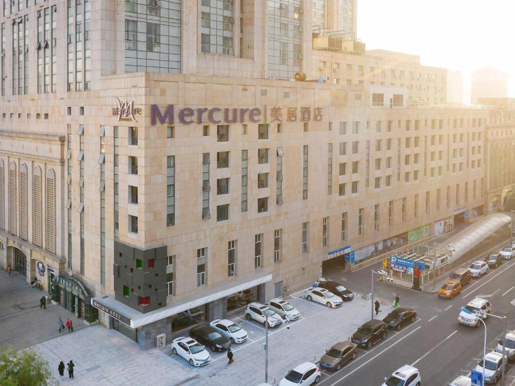 a large building with cars parked in front of it at Mercure Harbin Central Street Sophia Church in Harbin