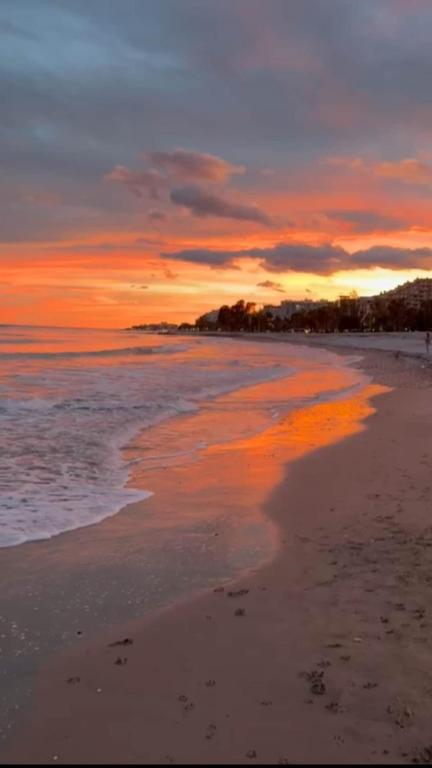 a sunset on a beach with the ocean at Playa Torre de la Sal - Primera Linea in La Estación
