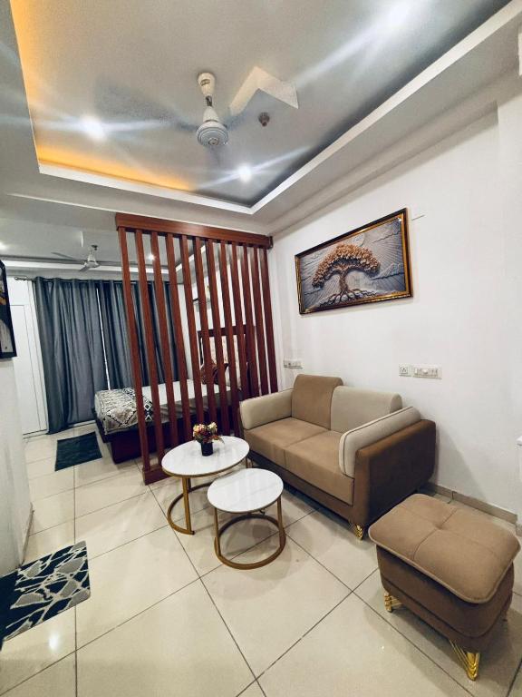 a living room with a couch and a table at Saffron Nest in Zirakpur