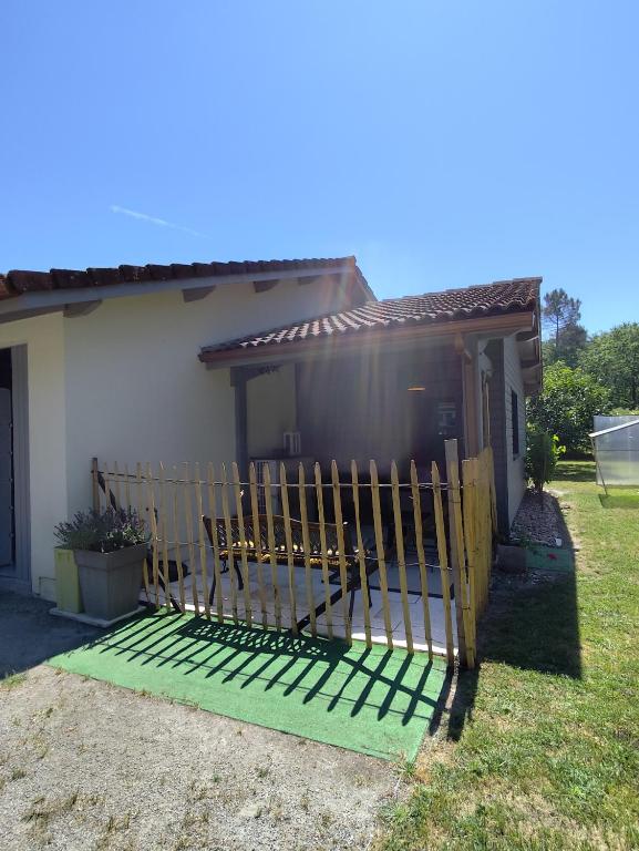a fence in front of a house at Le petit nid dans les bois in Castres-Gironde