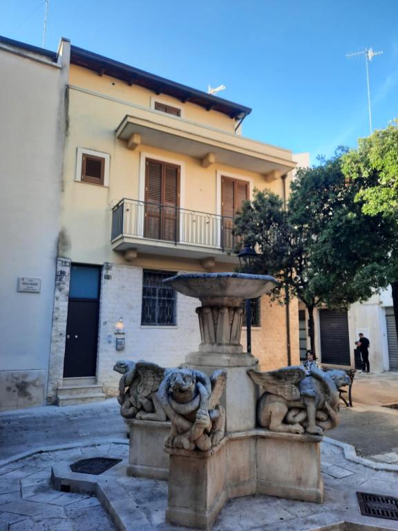 a stone fountain in front of a building at I 4 Leoni in Conversano