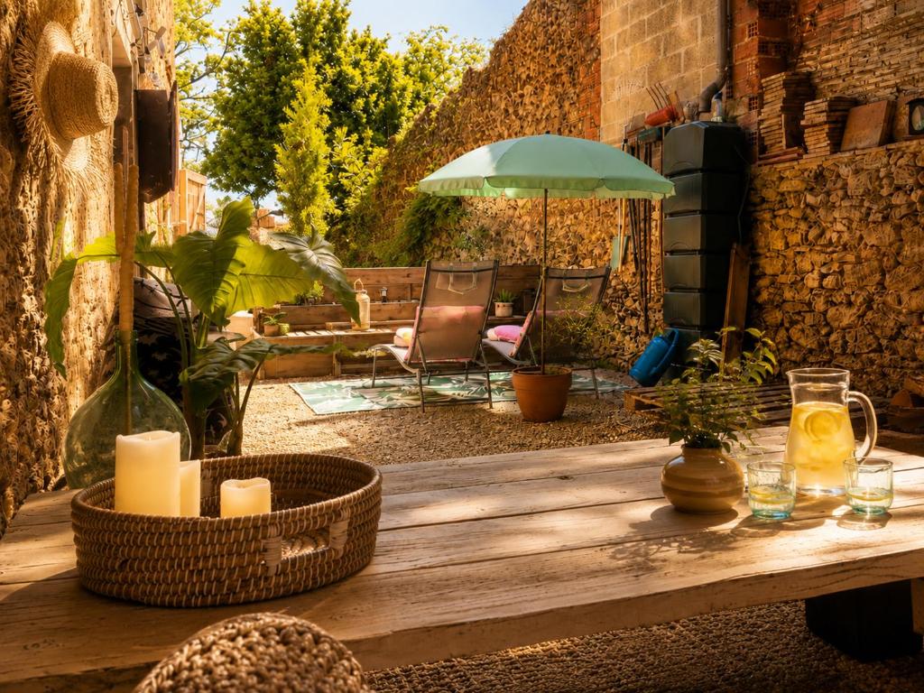 a wooden table with candles on a patio at Chez Cathy in Villandraut