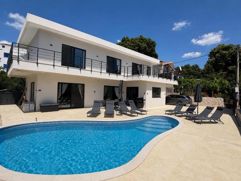 a villa with a swimming pool in front of a house at Villa LiRa Star Bar Montenegro - Exclusive Adriatic Villa with Private Pool Starry Sky Lounge in Stari Ulcinj