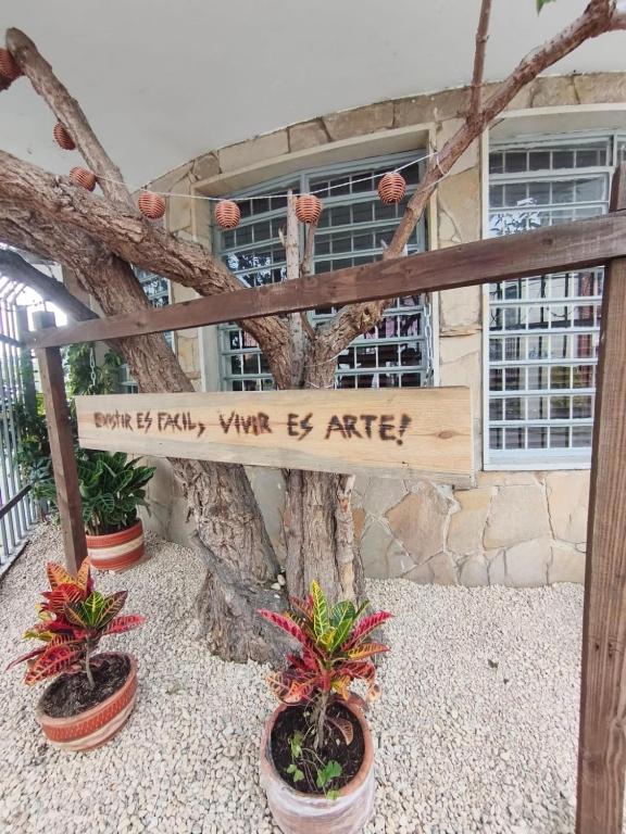 a sign in front of a building with plants at Casa Corferias in Bogotá