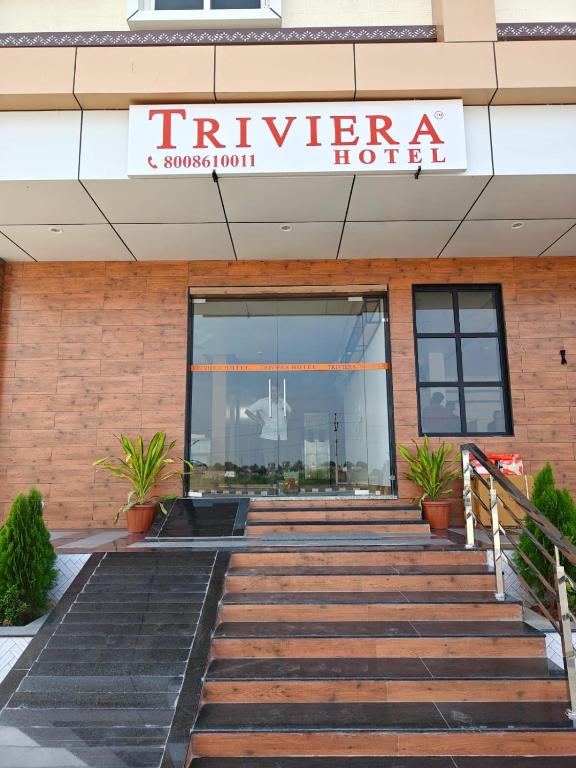 a building with a sign for a hotel at Trivera in Pidugurālla