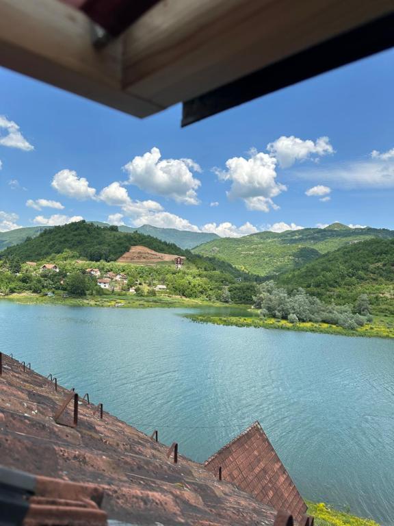 a view of a river with mountains in the background at Restoran Orahovica Konjic - sobe in Konjic