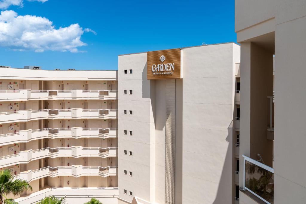 a building with a sign on the side of it at Cala Millor Garden Hotel - Adults Only in Cala Millor