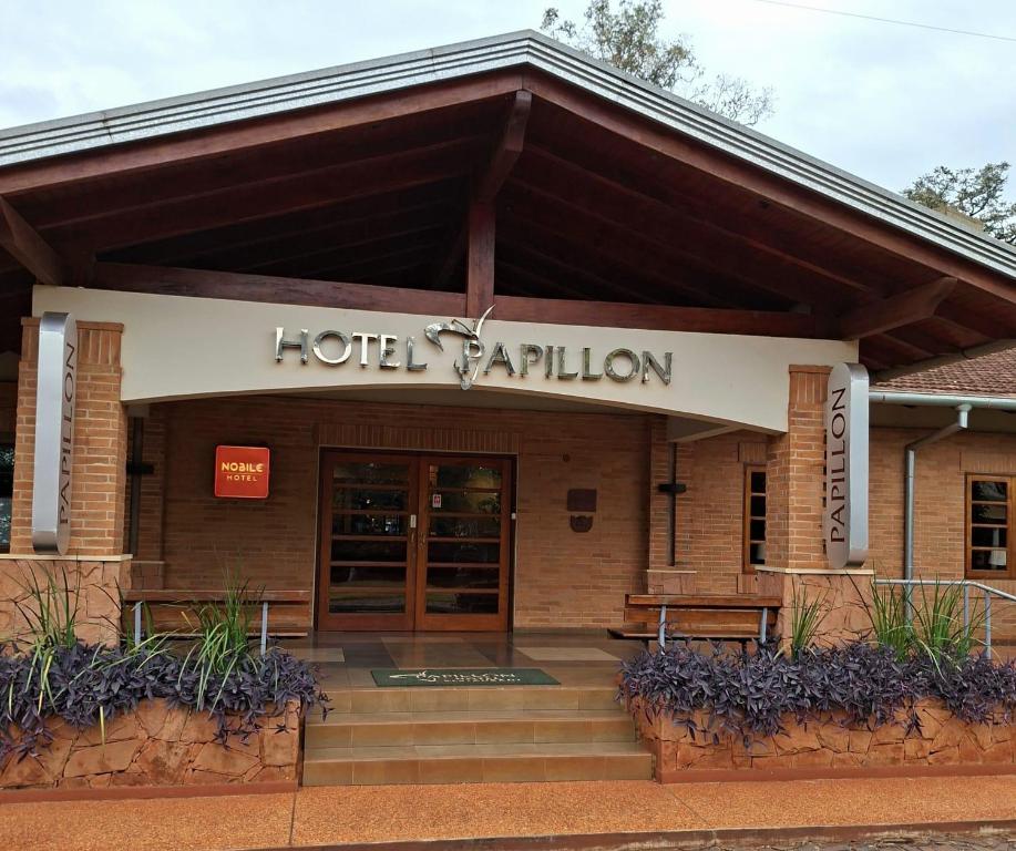 a hotel raion building with a sign that reads hotel raion at Nobile Hotel Papillon in Bella Vista