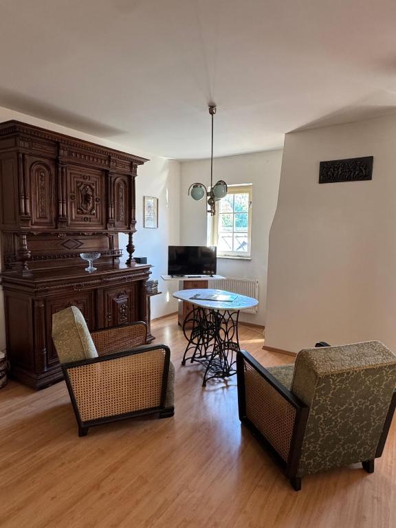 a living room with two chairs and a table at Apartmán Bonaparte in Loket