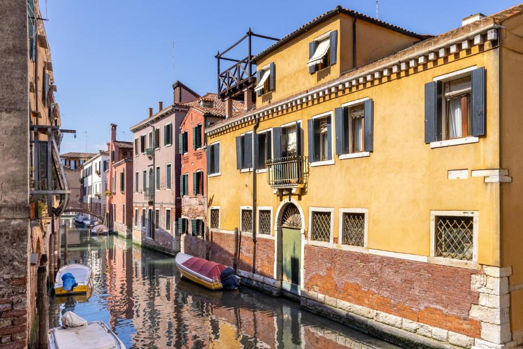 a view of a canal with buildings and boats at Erbe Canal View Private House in Venice
