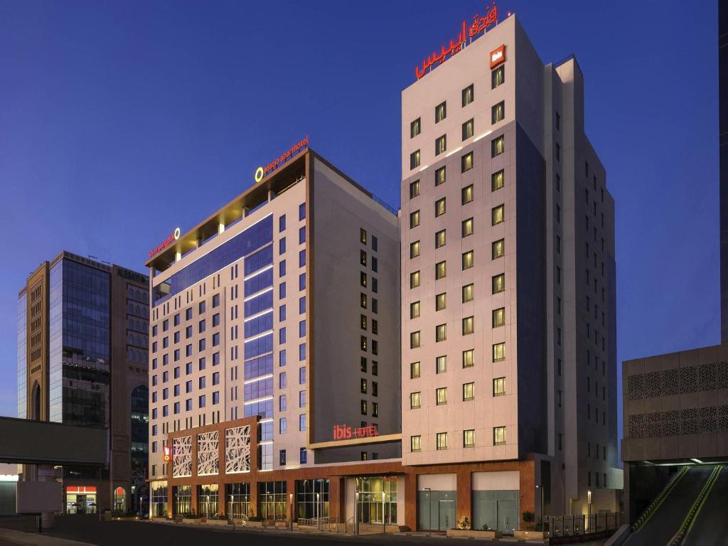 two tall buildings are next to each other at ibis Jeddah City Center in Jeddah
