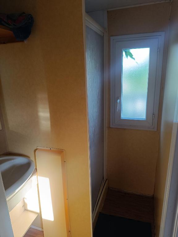 a bathroom with a sink and a window at Mobile homes a la ferme in Ille-sur-Têt
