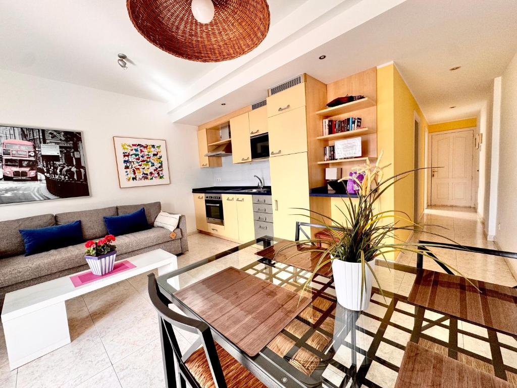 a living room with a couch and a glass table at Departamento Corriquia in Playa Blanca