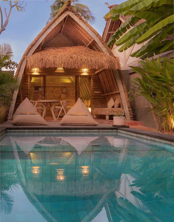 a resort with a swimming pool in front of a house at Private Pool Romantic Villa - Adults Only - VILLA PALMA - Gili Meno in Gili Meno