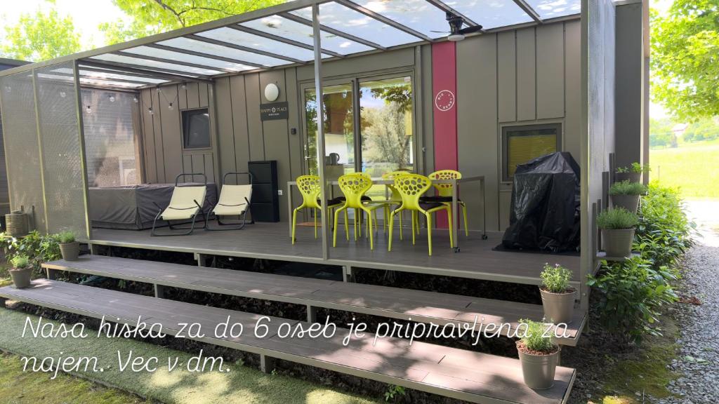 a screened in porch with chairs and a table at HappyPlace - Kolpa PremiumMobileHome in Metlika