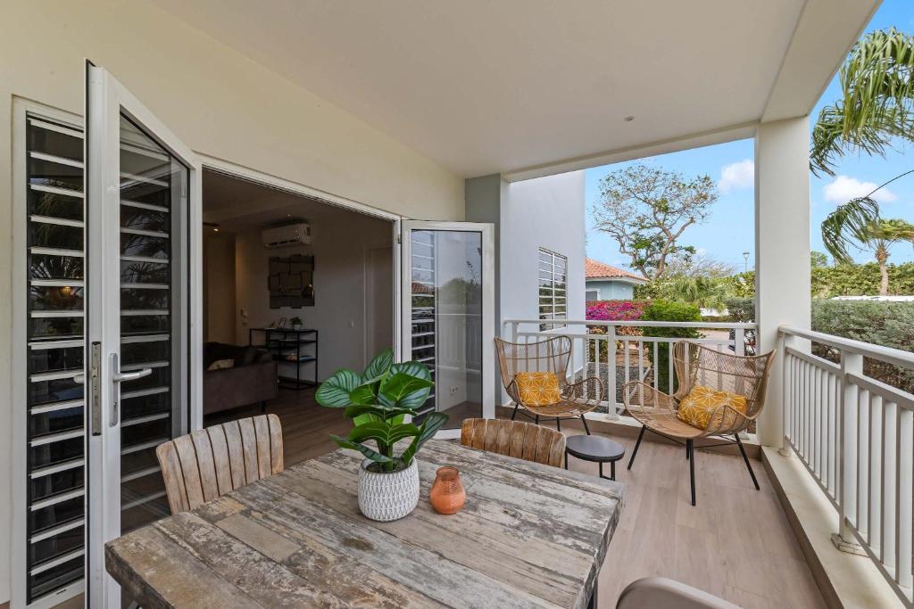 a dining room with a table and chairs on a balcony at Apartamento Sorbos in Dorp Sint Michiel