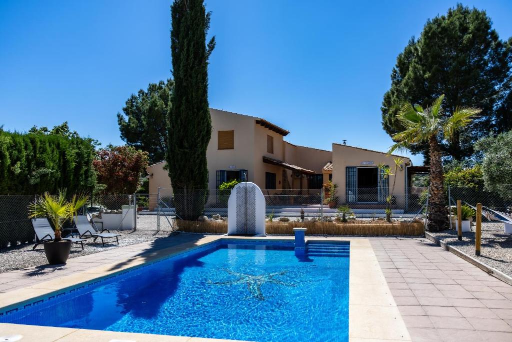 a swimming pool in front of a house at Casa Sabor de la Vida in Abarán
