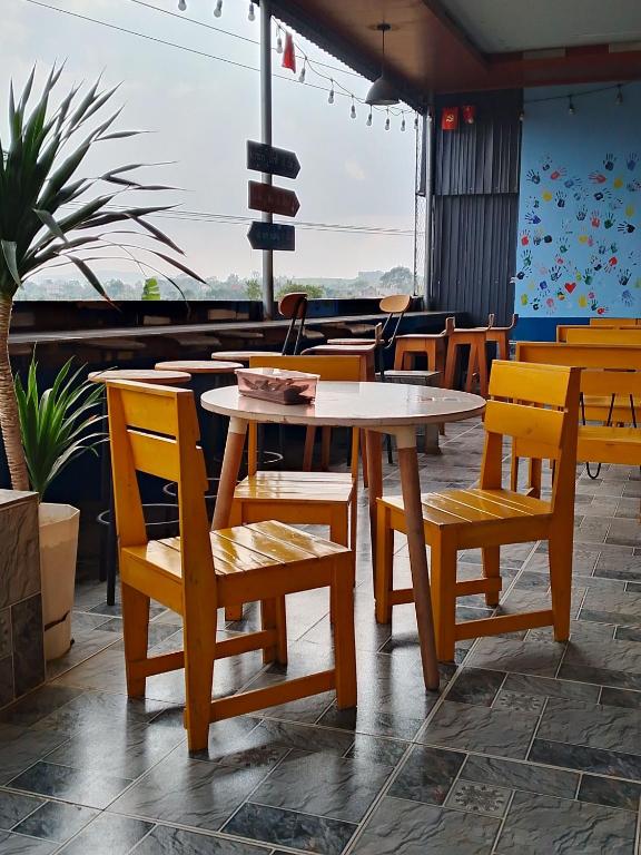 a group of tables and chairs in a restaurant at Home in Hố Nai