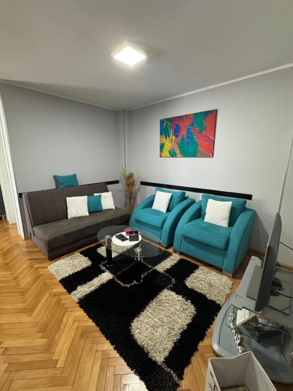 a living room with two couches and a television at M&G centar grada in Požarevac