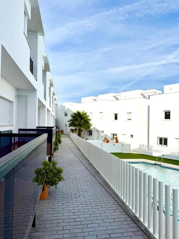 a balcony with white buildings and a brick walkway at Apartamentos La Janda in Benalup Casas Viejas