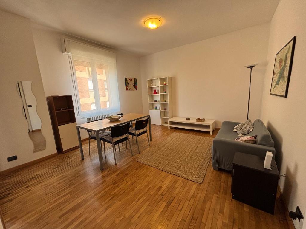 a living room with a couch and a table at Montegrappa smart stay Modena in Modena