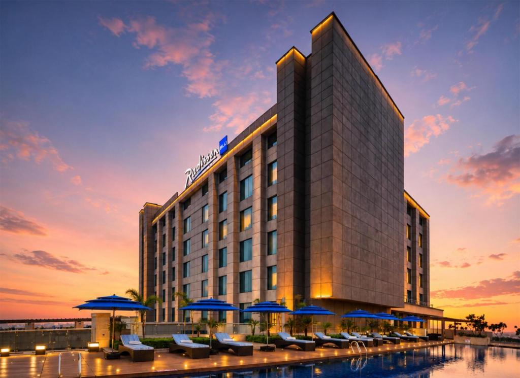 a rendering of a hotel at sunset with chairs and umbrellas at Radisson Blu Hotel New Delhi Paschim Vihar in New Delhi