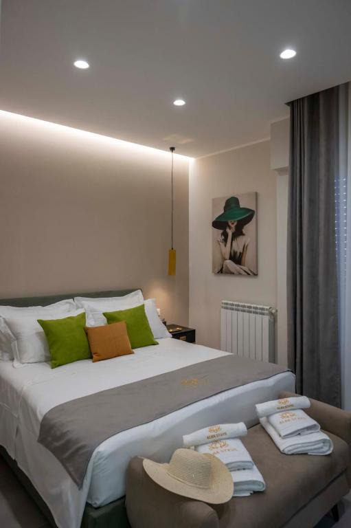 a bedroom with a large bed with hats on it at Alba Stays in Ladispoli