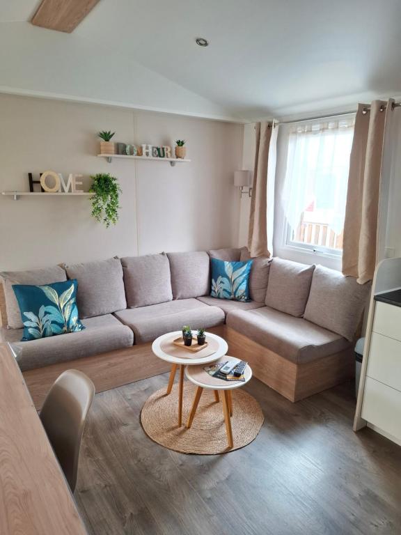 a living room with a couch and a table at La plage in Canet-en-Roussillon
