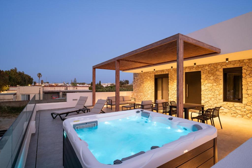 a hot tub on the deck of a house at Besa Luxury Villas in Kos