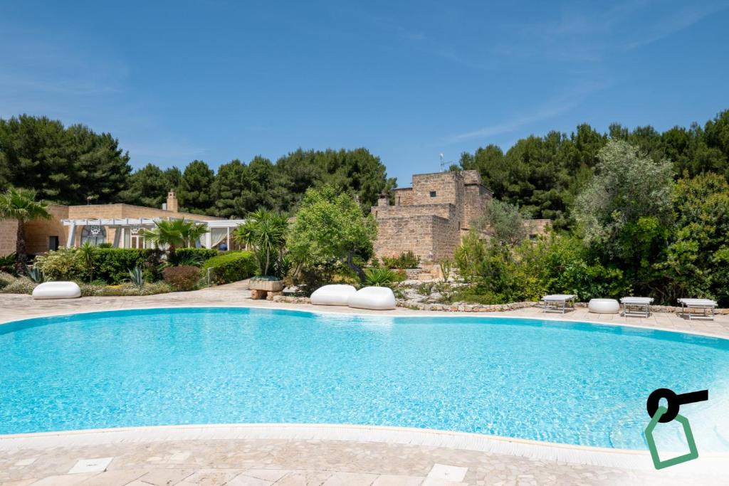 a swimming pool in a yard with a castle in the background at Hotiday Gallipoli Sannicola in Gallipoli