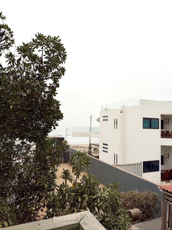 a view of a building with trees in front of it at Ola in Puchuncaví