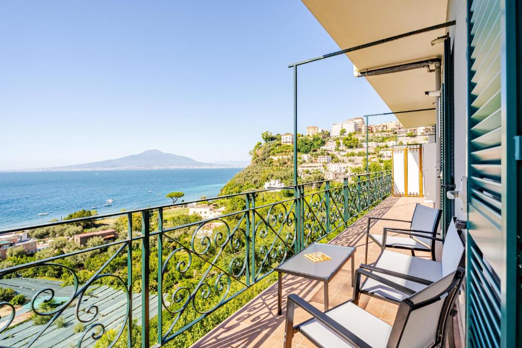 a balcony with chairs and a view of the ocean at Seventy Steps in Vico Equense