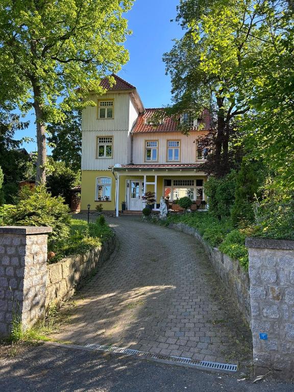 a house with a cobblestone road in front of it at Castrum Visum Wernigerode in Wernigerode