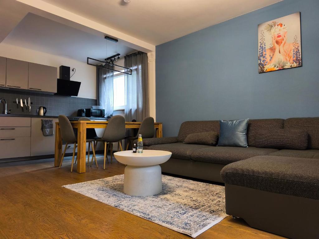 a living room with a couch and a table at Family Suites & Parking in Baden-Baden