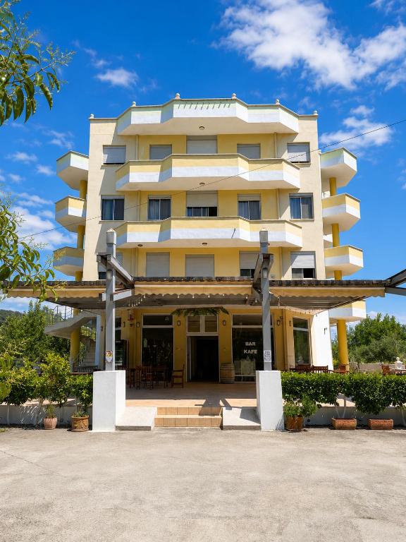 a large yellow building with a lot of windows at Hotel Garden Albania in Golem