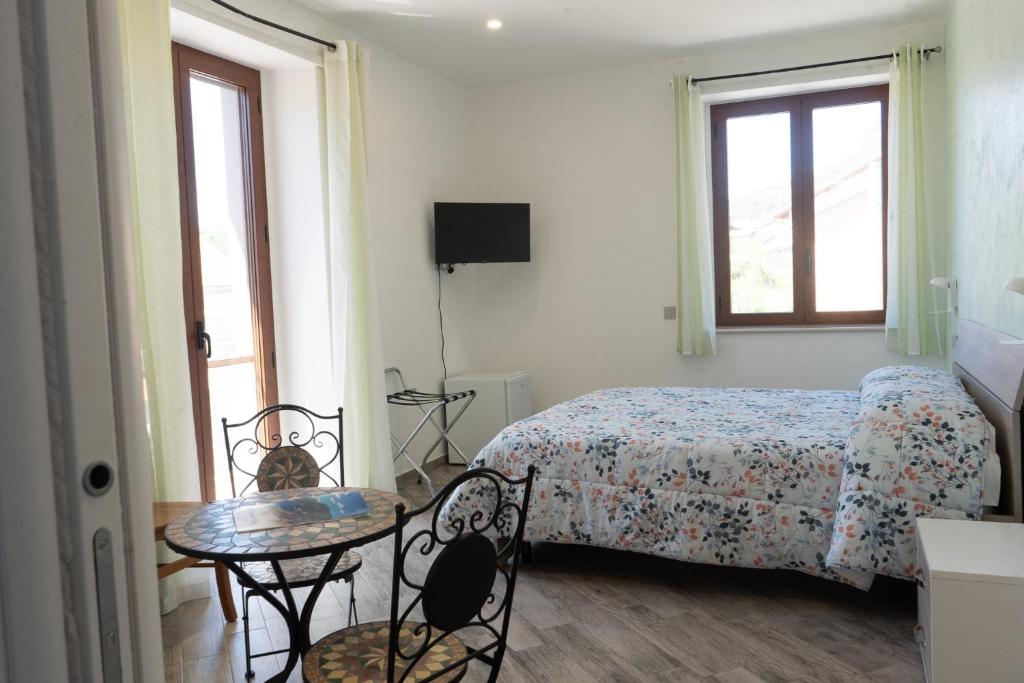 a bedroom with a bed and a table and chairs at La dolce vita in Agerola