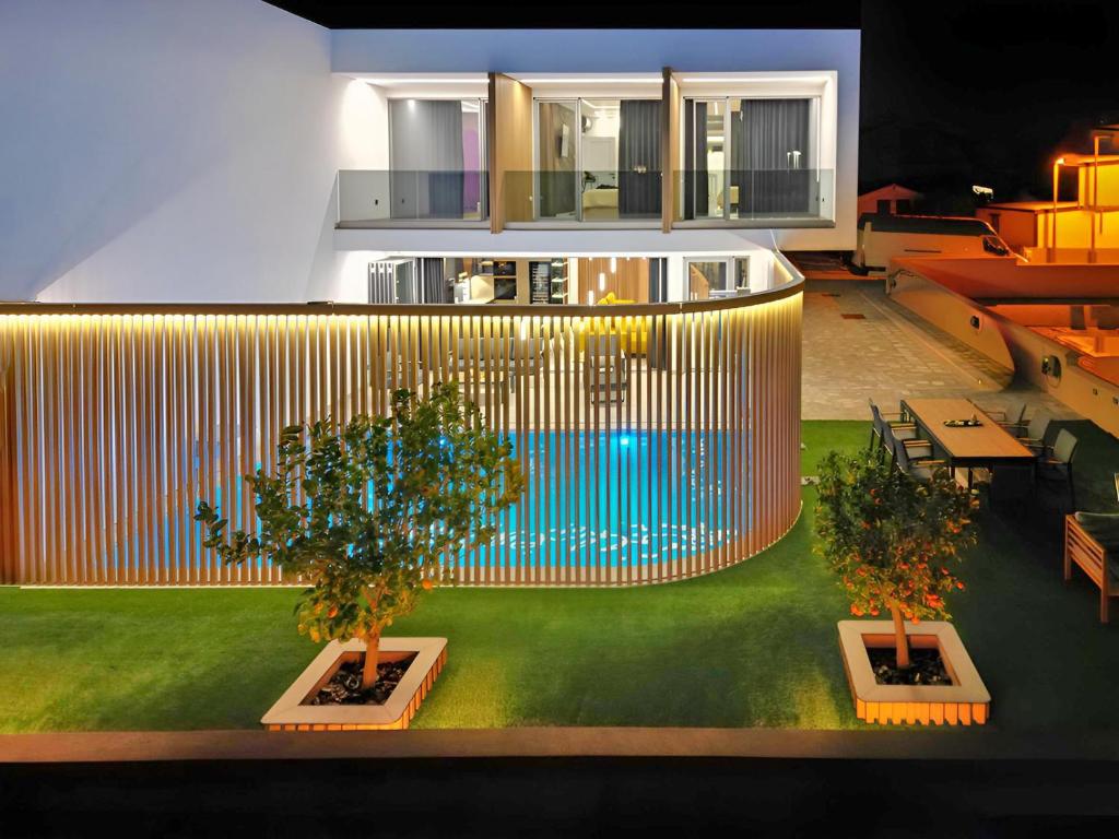 a building with two trees and a pool in it at Timm - Luxury Villas in Vodice
