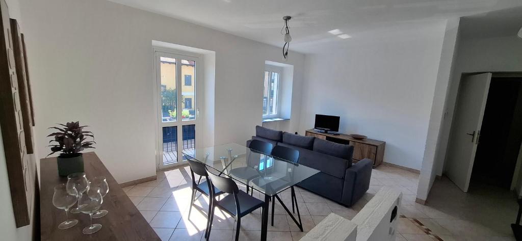a living room with a glass table and a blue couch at casArona in Arona